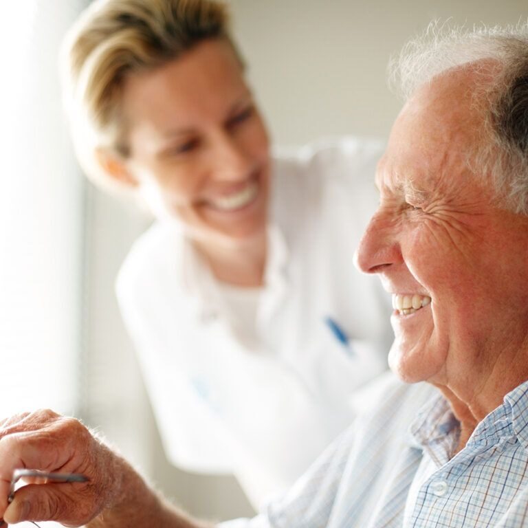 A woman smiling next to an older man.